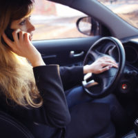 Lady talking on the phone while driving.jpg.crdownload