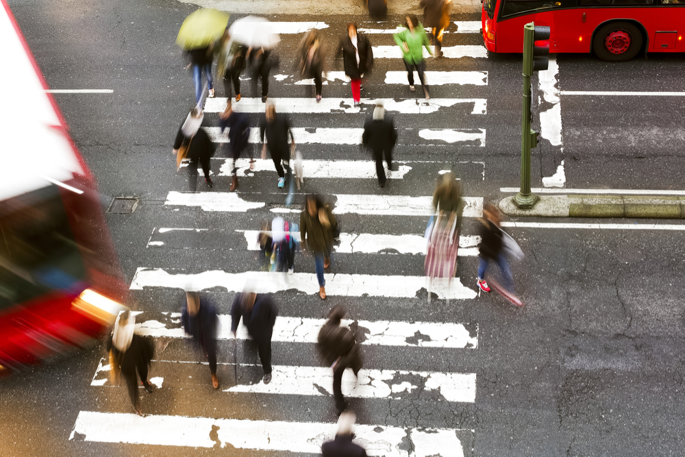 a bunch of pedestrians crossing the street.jpg.crdownload