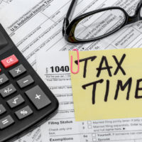 tax form with calculator and glasses