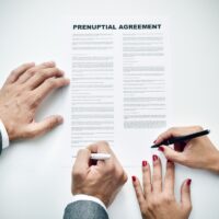 young man an woman signing a prenuptial agreement young man an woman signing a prenuptial agreement
