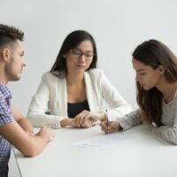 Young wife sign divorce papers in lawyer office Young wife sign divorce papers in lawyer office
