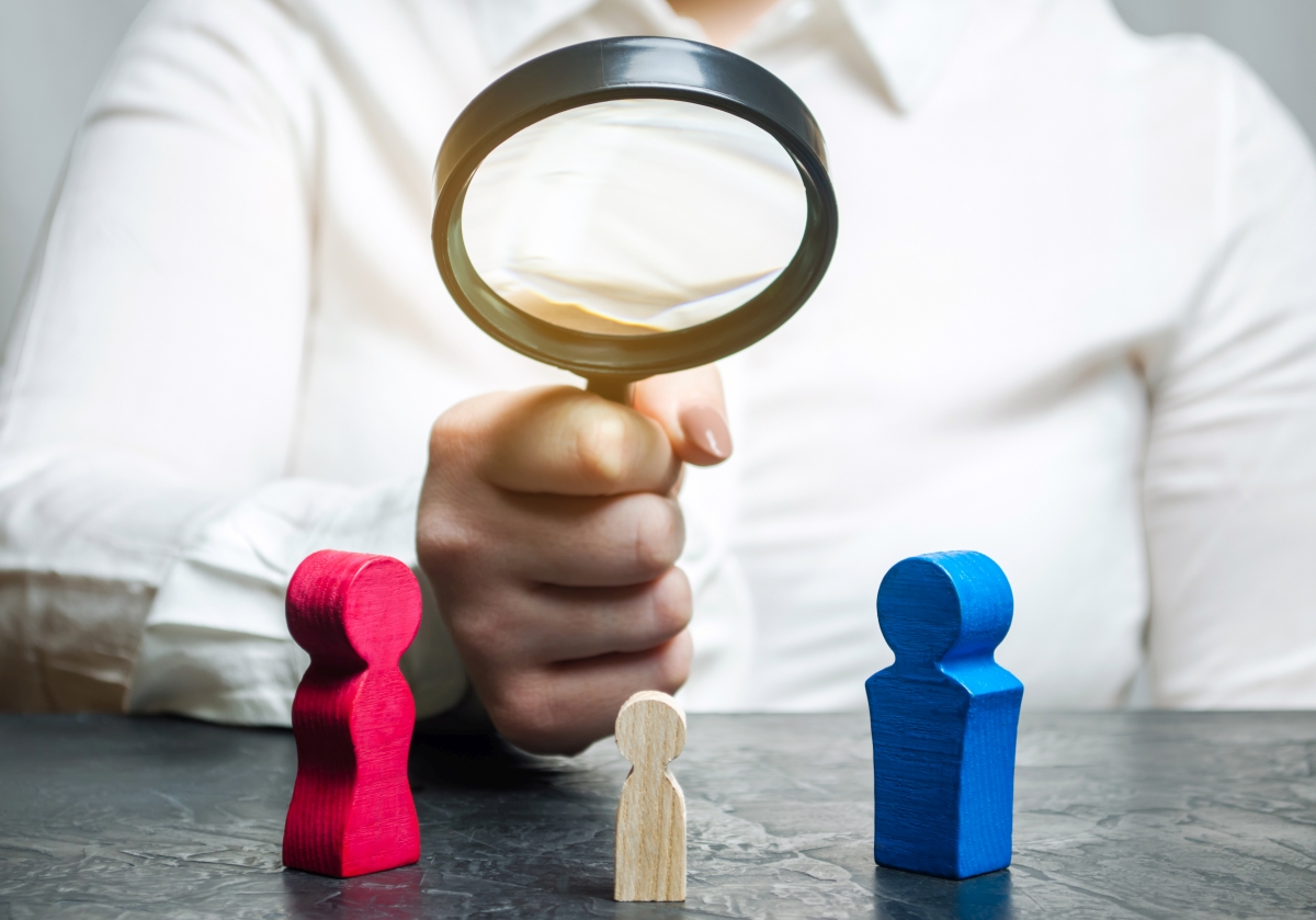 The doctor’s hand is holding a magnifying glass over the child’s figure. The court decision on custody of the child by one of the parents after the divorce. Genetic analysis on the relationship. Baby The doctor’s hand is holding a magnifying glass over the child’s figure. The court decision on custody of the child by one of the parents after the divorce. Genetic analysis on the relationship. Baby