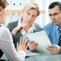 mid-adult couple meeting with financial planner