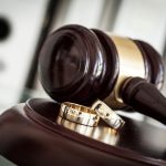 Divorce concept with gavel and wedding rings