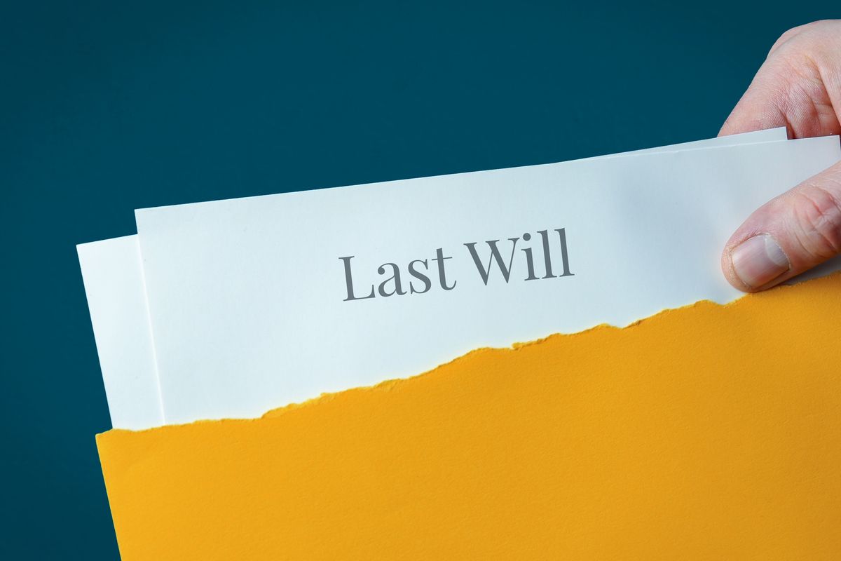 Last Will. Hand opens envelope and takes out documents. Post let