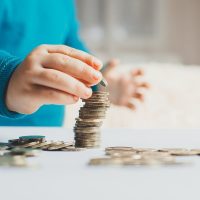 child coins hands slivaet in the stack in stack growth, holding, investment
