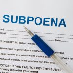 Close up picture of Subpoena with pen.