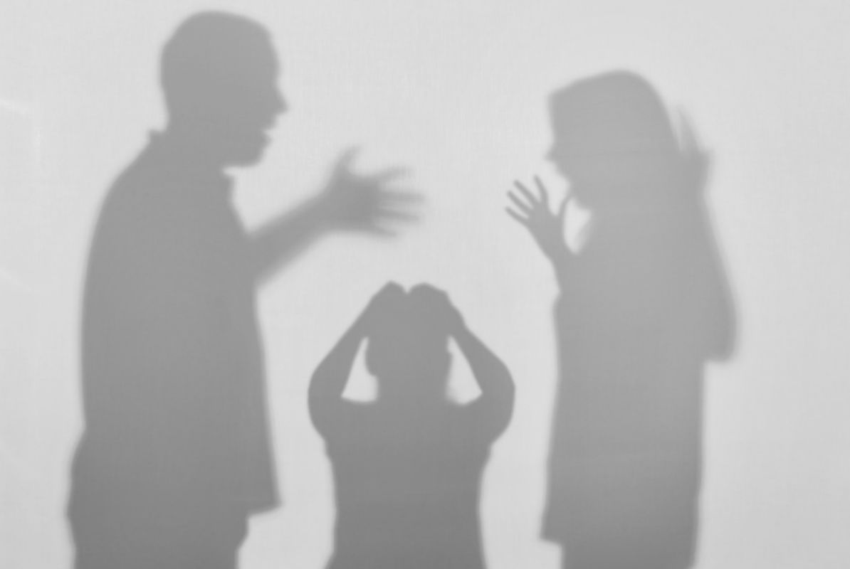 Silhouettes of quarreling parents and little child on white background. Domestic violence concept