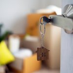 The house key for unlocking a new house is plugged into the door.