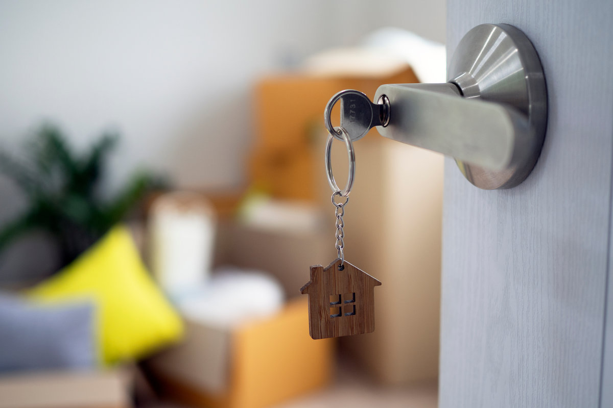 The house key for unlocking a new house is plugged into the door.