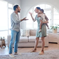 Frustrated couple, argument and fighting with baby for breakup, divorce or disagreement in living room dispute. Upset, man and woman with child in toxic relationship or conflict for affair at home